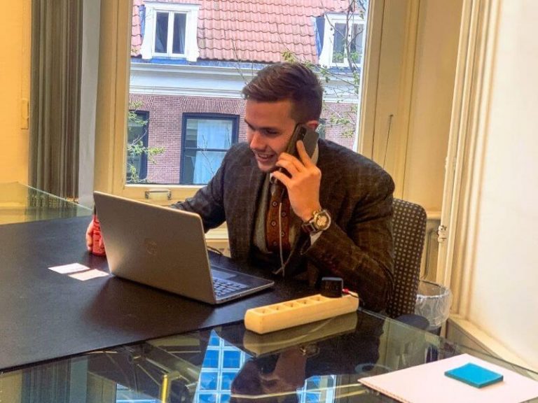 Account Manager Okko Uitenbroek on Phone Call at the Office with Laptop